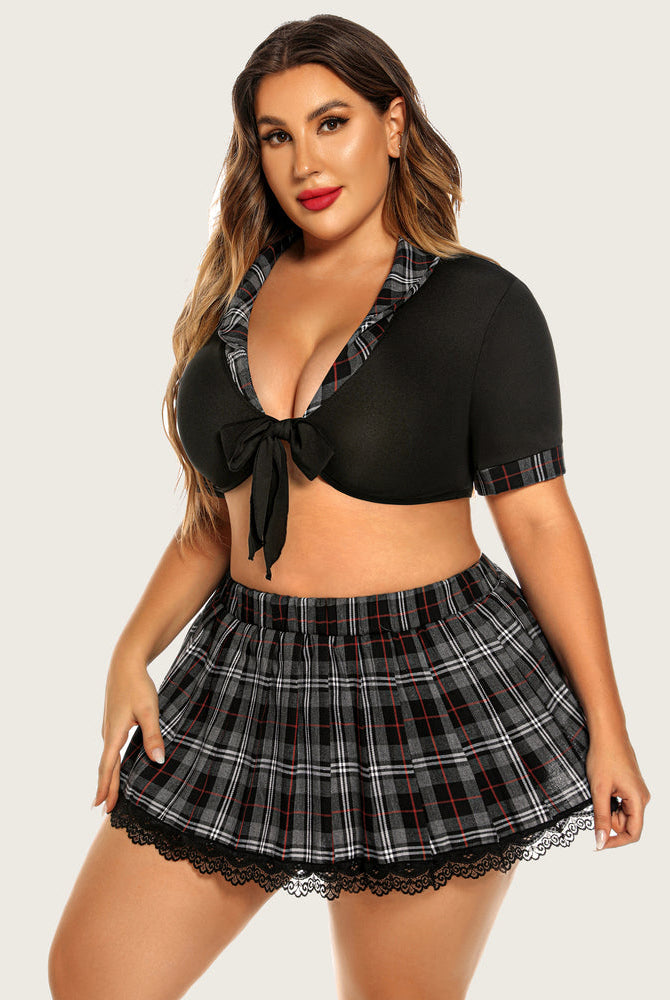 Plus size schoolgirl lingerie set: black tie top, gray plaid mini skirt, lace trim, confident.