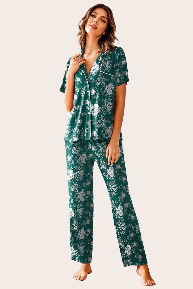 Green floral print notch collar pajama set with white piping. Short sleeve top and long pants for women.