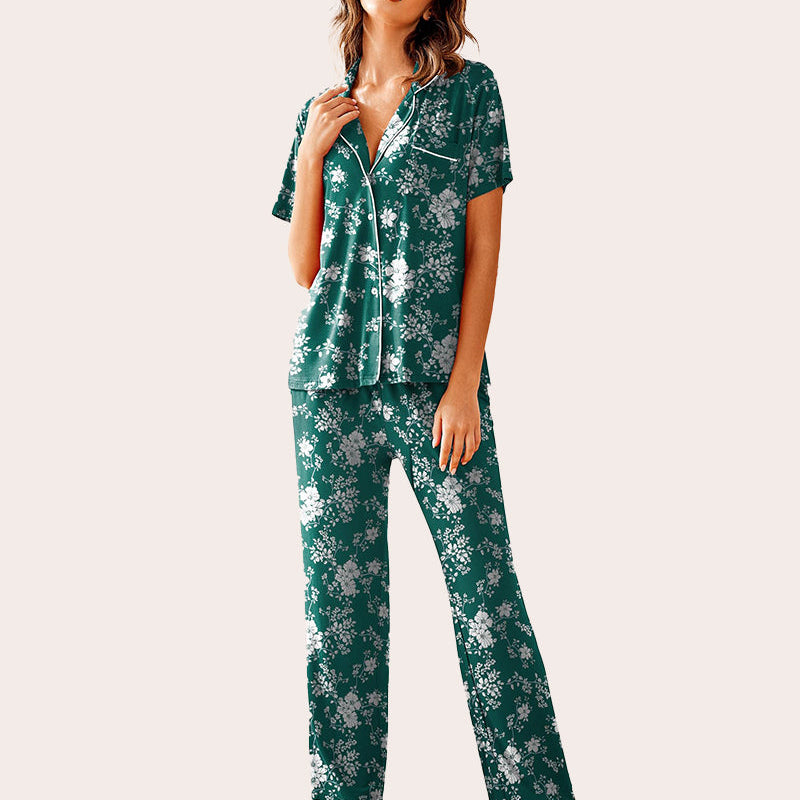 Green floral print notch collar pajama set with white piping. Short sleeve top and long pants for women.
