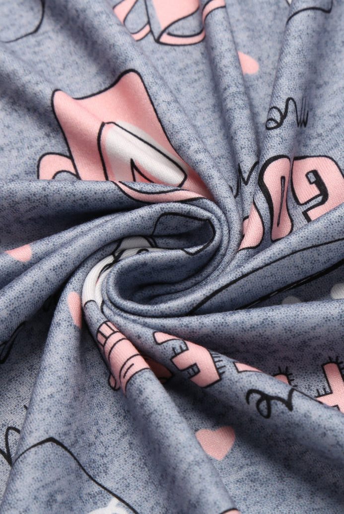 Grey printed pajama tank top fabric with cups, hearts, and doodle motifs.