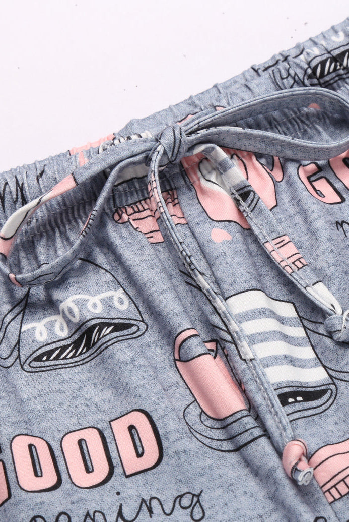Grey printed pajama shorts with elastic waist, drawstring, and coffee cup graphic.