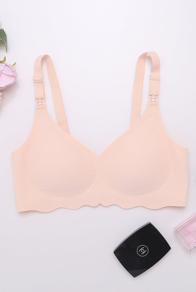 Peach seamless maternity bra with adjustable straps, ultra-comfortable for nursing mothers.