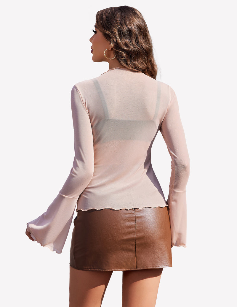 Nude mesh top with bell sleeves and brown leather skirt, a stylish and confident look.