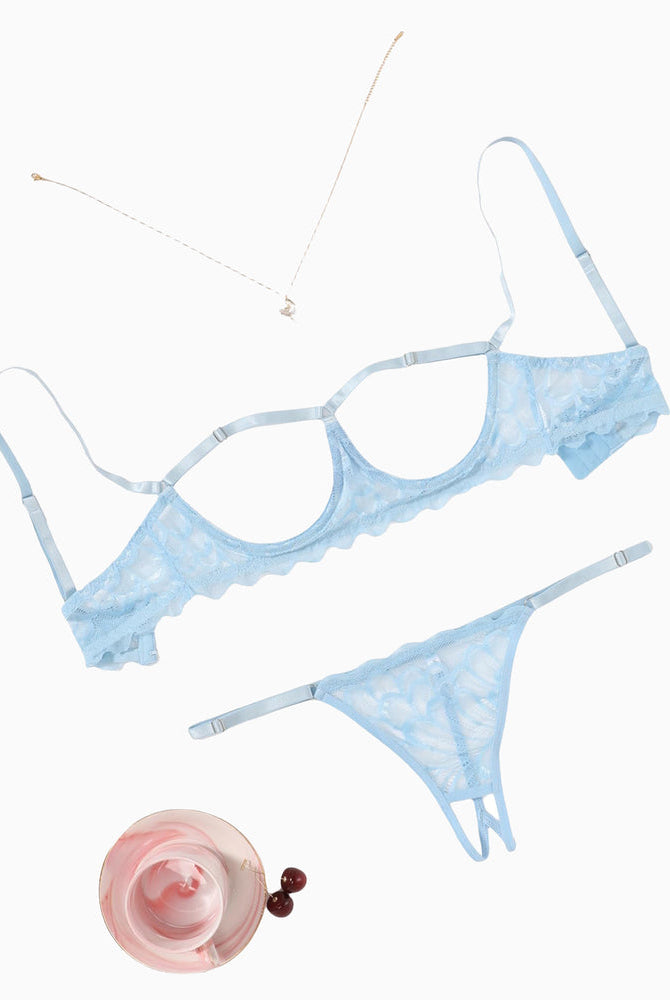 Light blue lace bra and thong set flat lay with matching accessories.