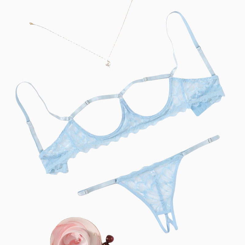 Light blue lace bra and thong set flat lay with matching accessories.