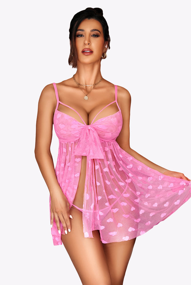 Front view of pink lace mesh babydoll nighty with heart pattern and tie-front balconette cups
