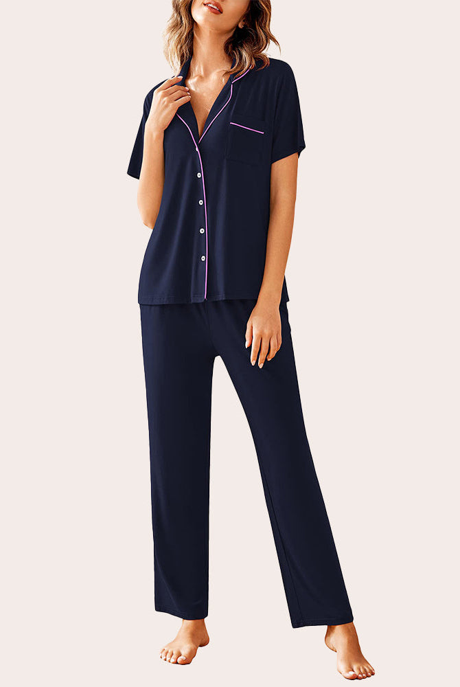 Navy blue pajama set. Button-down shirt and long pants with pink details. Comfortable sleepwear.