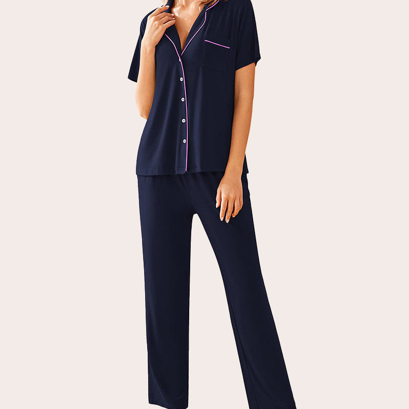Navy blue pajama set. Button-down shirt and long pants with pink details. Comfortable sleepwear.