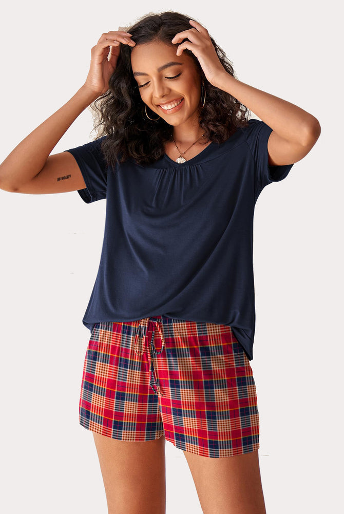 Women's navy V-neck top with red plaid shorts pajama set. Comfortable rayon sleepwear.