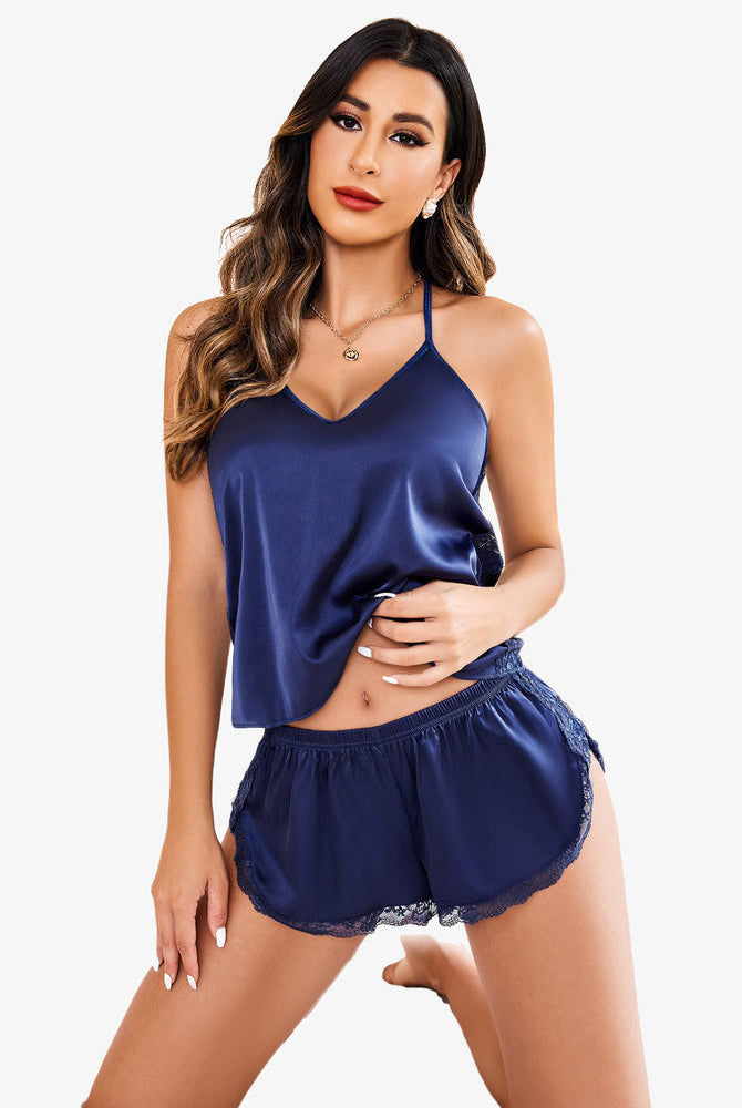 Navy blue satin pajama set with lace trim, cami top and shorts, elegant sleepwear for women.