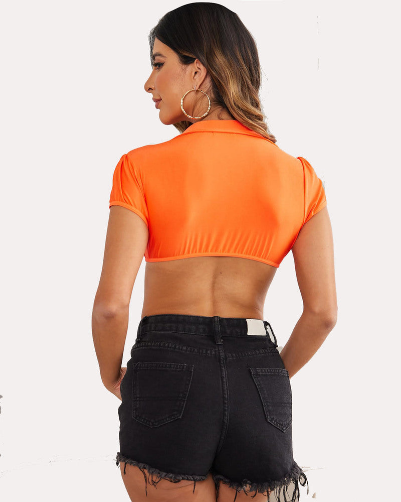 Orange crop top cosplay shirt with short sleeves and collared design paired with black denim shorts.