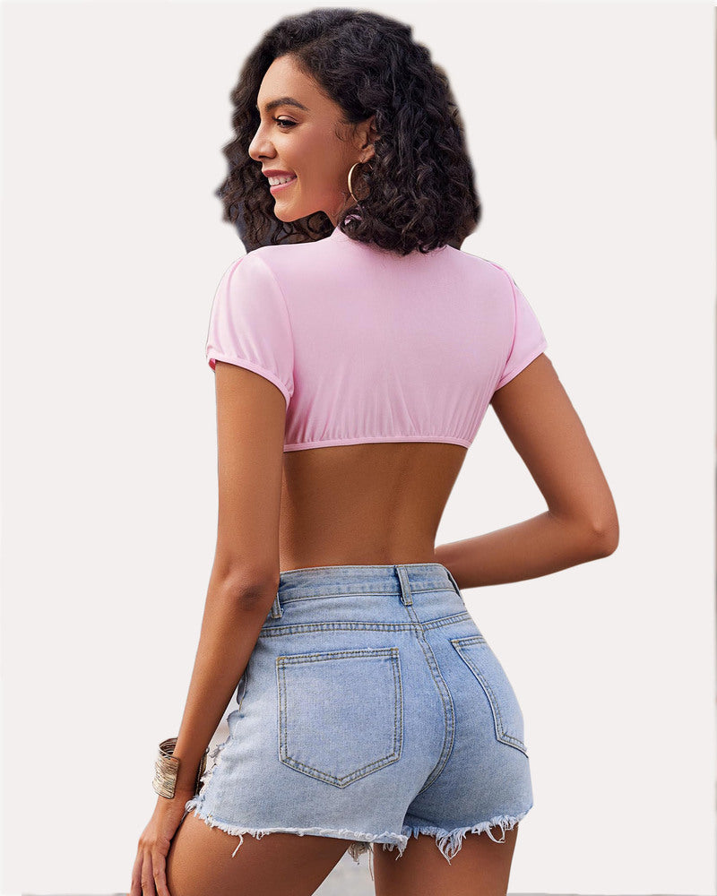 Pink short sleeve crop top with open back, worn with denim shorts, ideal for cosplay or daily wear.