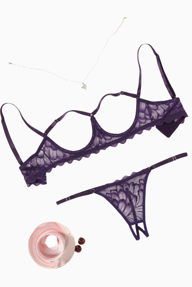 Lace bra and thong-style panty set, scalloped trim, dark purple, flat lay.