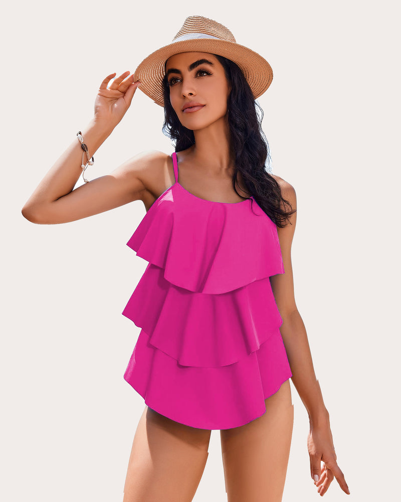 Women's hot pink ruffle tankini swimsuit with adjustable straps. Beachwear with layered design.