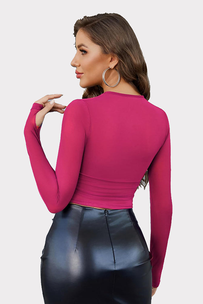 Magenta mesh crop top with long sleeves, thumb holes, black skirt. Perfect party wear.