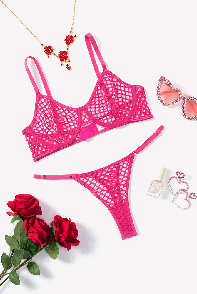 Hot pink fishnet hollow-out push-up bra and thong set, flat lay