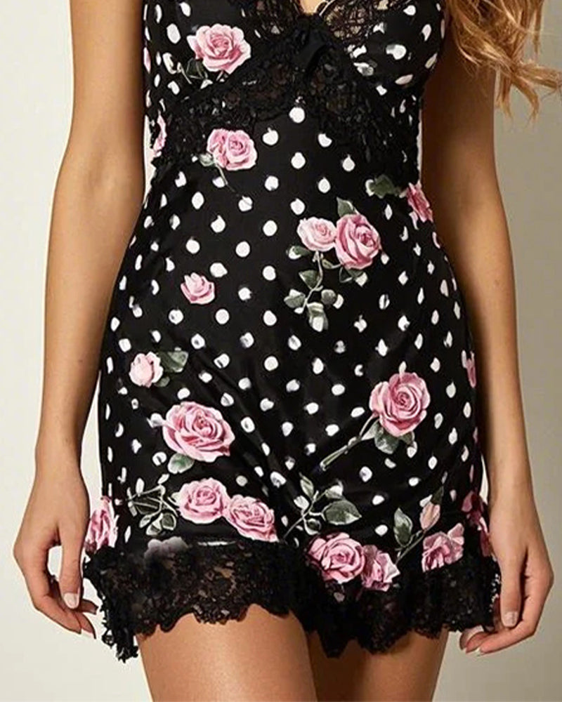 Black sleep dress with pink roses, polka dots, and lace, perfect for sleep and movement.