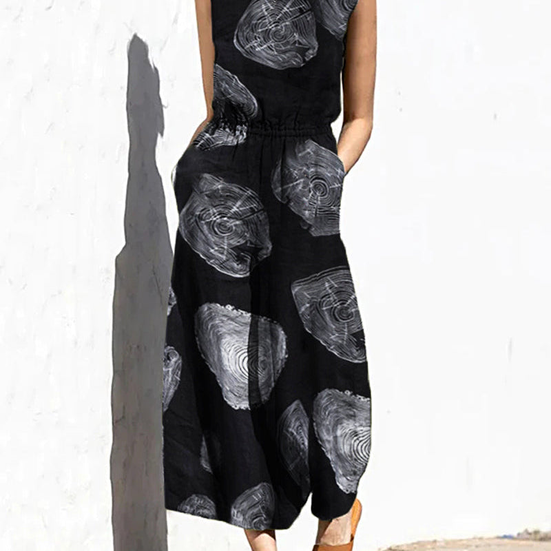 Black printed sleeveless jumpsuit with elastic waist and abstract swirl pattern