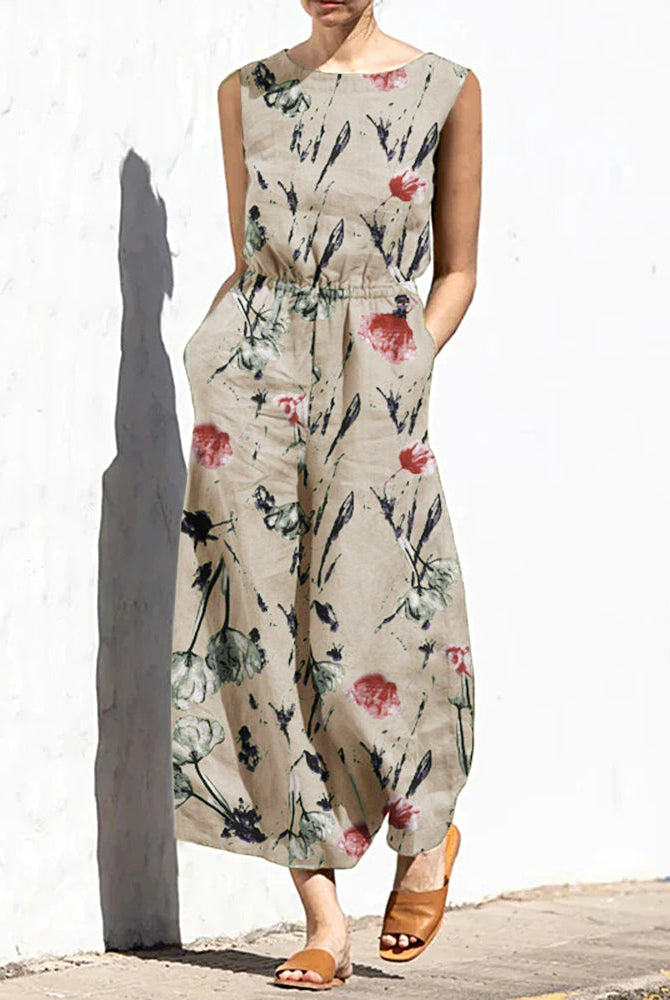 Cream printed sleeveless jumpsuit with elastic waist and floral leaf pattern