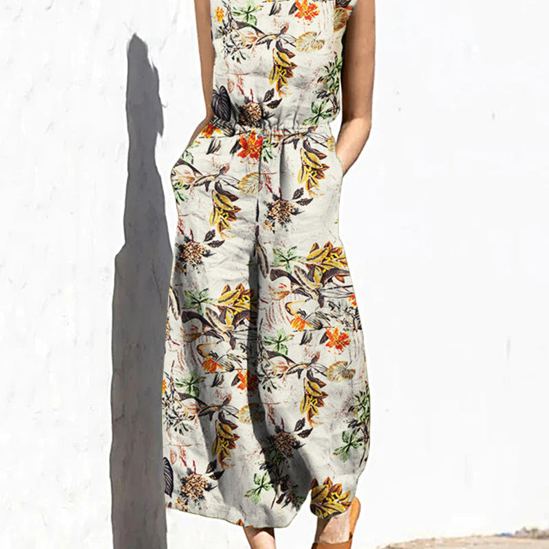 Light cream printed sleeveless jumpsuit with elastic waist and botanical bird pattern