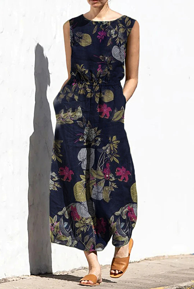 Navy blue printed sleeveless jumpsuit with elastic waist and multicolor floral leaves
