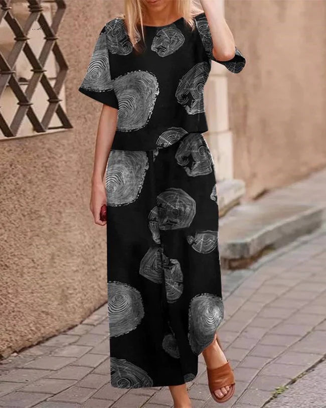 Black linen two-piece set with tree ring pattern for women. Loose fit top and wide leg pants.