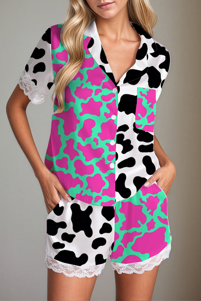 Women's satin pajama set with cow print, short sleeves, shorts, and lace trim. Silk fabric.
