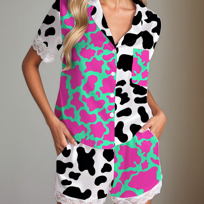 Women's satin pajama set with cow print, short sleeves, shorts, and lace trim. Silk fabric.