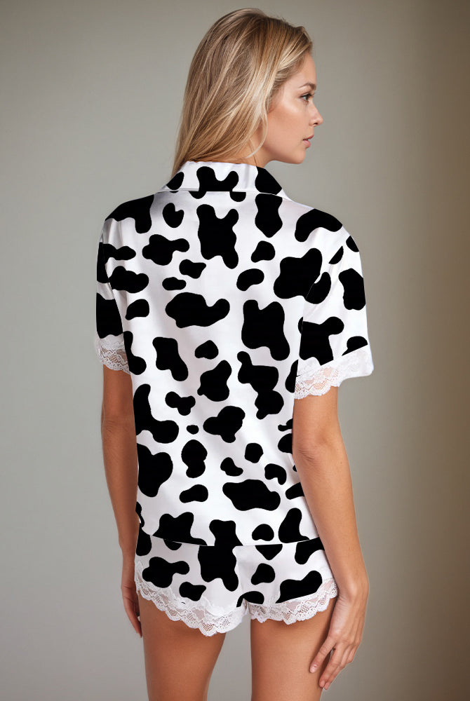 Women's cow print satin pajama set with lace trim. Comfortable silk short-sleeved shirt and shorts.