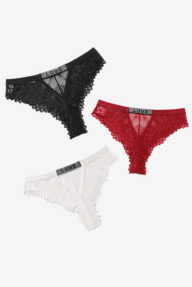 Lace thong panties with rhinestone 'LOVE' detail in black, red, and white. Soft, elegant design.