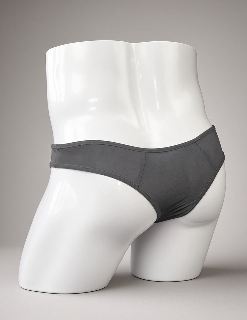 Gray sheer men’s G-string thong on a white mannequin