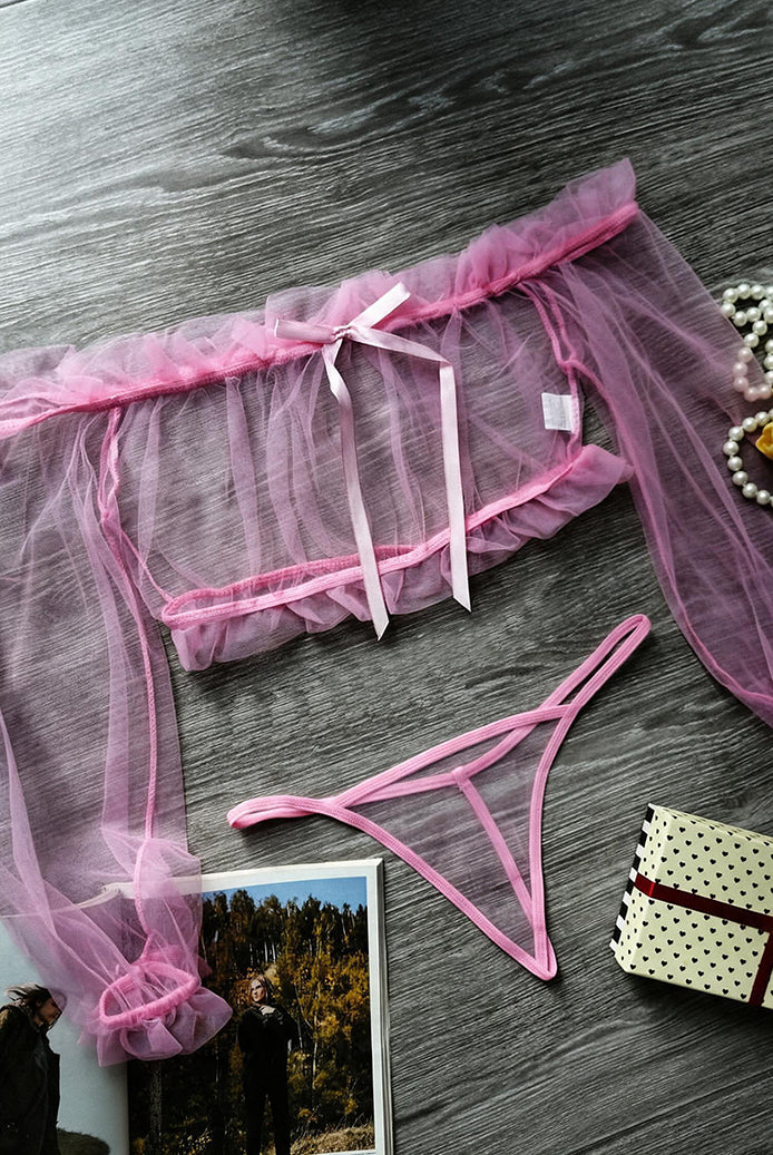 Pink sheer off-shoulder crop top and matching crotchless thong set, flat lay