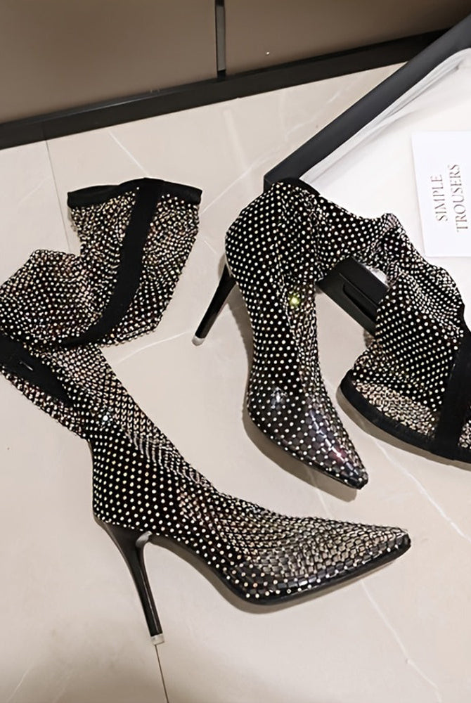 Black rhinestone fishnet over-the-knee stiletto boots, pair on display