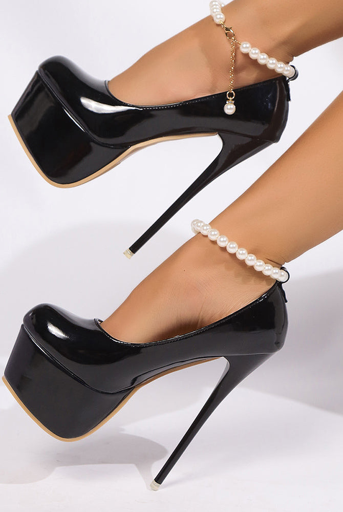 Black patent platform pumps with pearl anklet chain detail and gold-trim sole