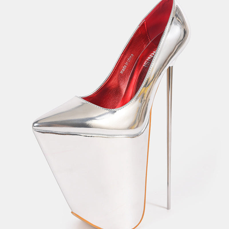 Silver patent platform stiletto pump with pointed toe, red interior, and thin stiletto heel