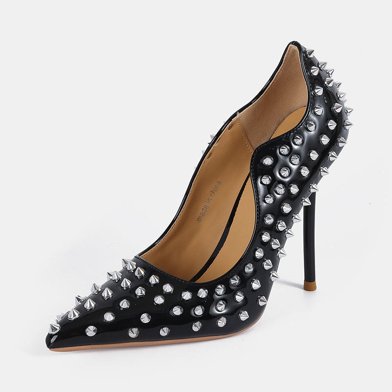 Black patent pointed-toe stiletto pump with silver spike studs, high heel