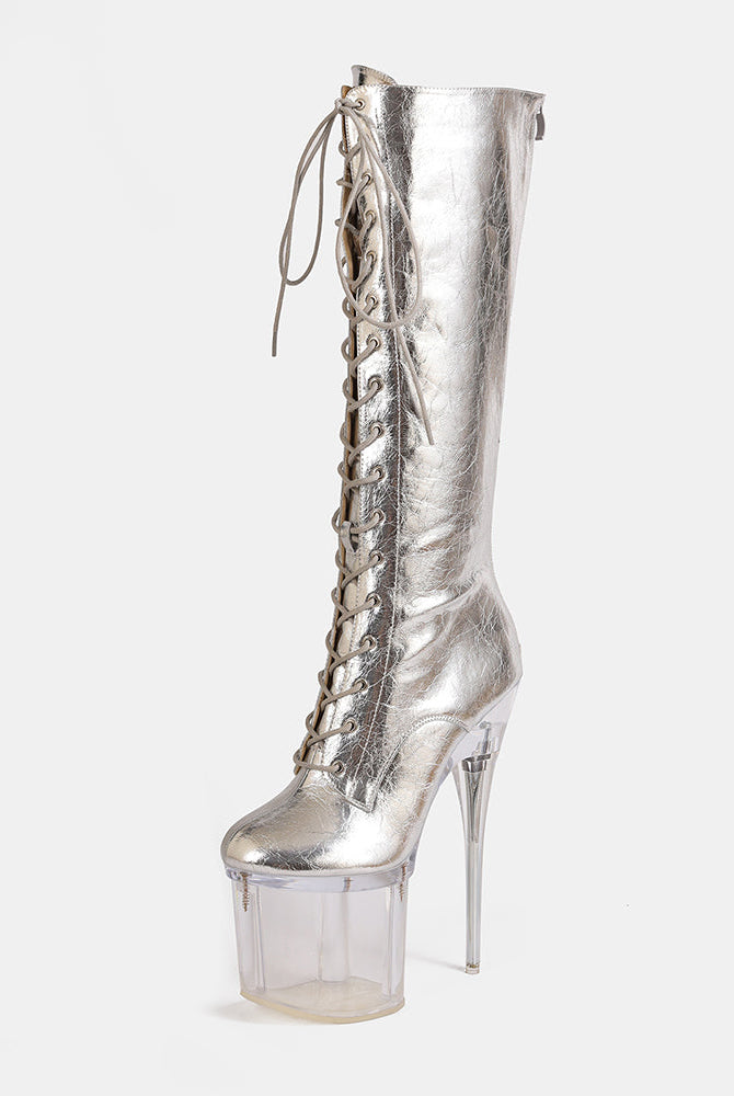Gold metallic knee-high lace-up stiletto boot with clear platform heel, angled view