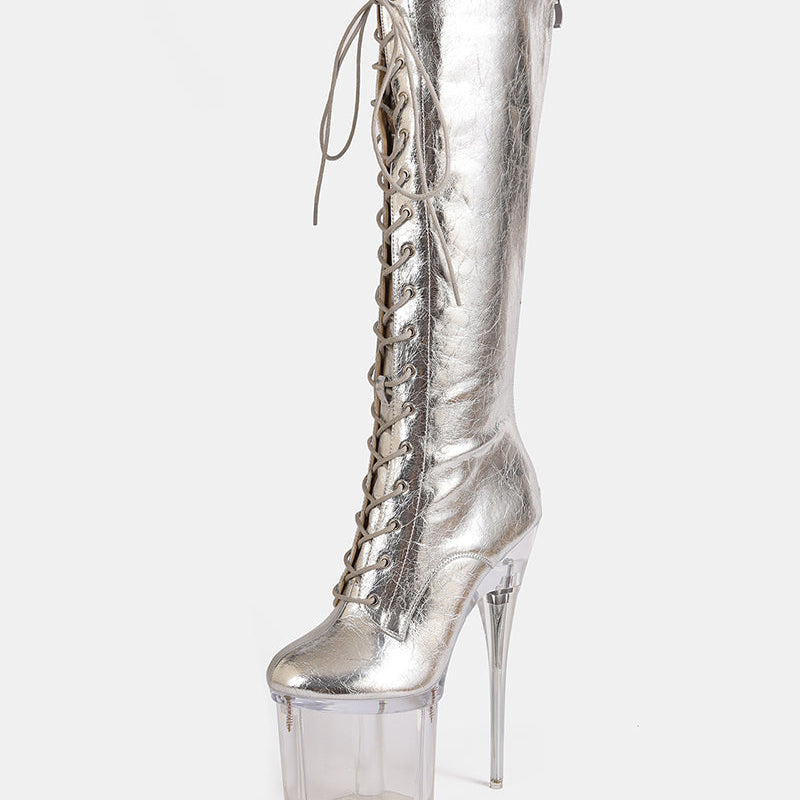 Gold metallic knee-high lace-up stiletto boot with clear platform heel, angled view