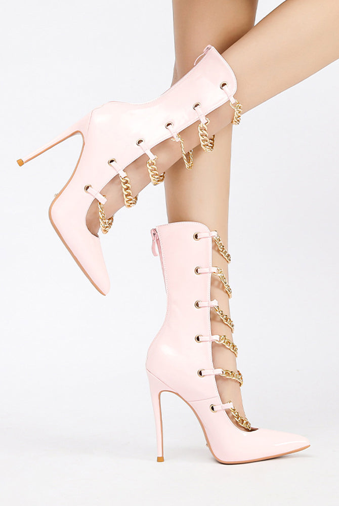 Light pink patent ankle boots with gold chain wrap and white eyelet laces.