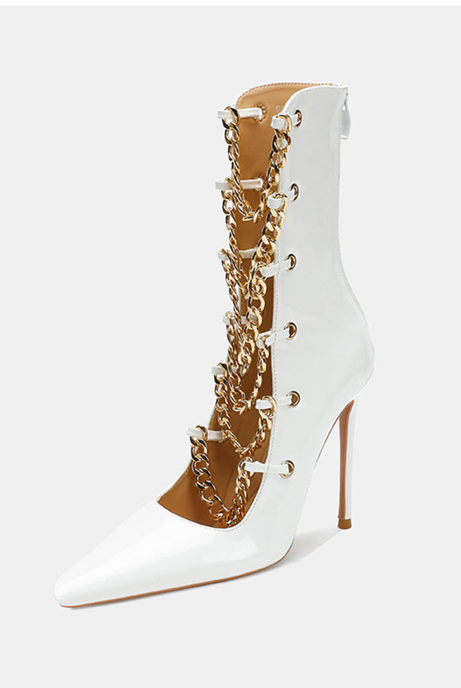 White patent stiletto ankle boot with gold chain front and tapered toe.