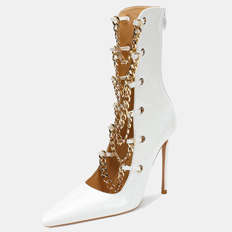 White patent stiletto ankle boot with gold chain front and tapered toe.