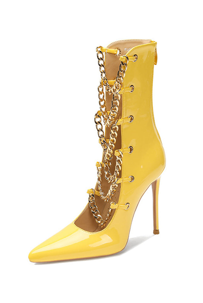 Yellow patent stiletto ankle boot with gold chain detail and slim heel.