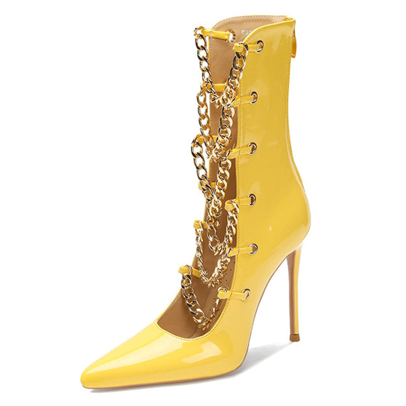 Yellow patent stiletto ankle boot with gold chain detail and slim heel.