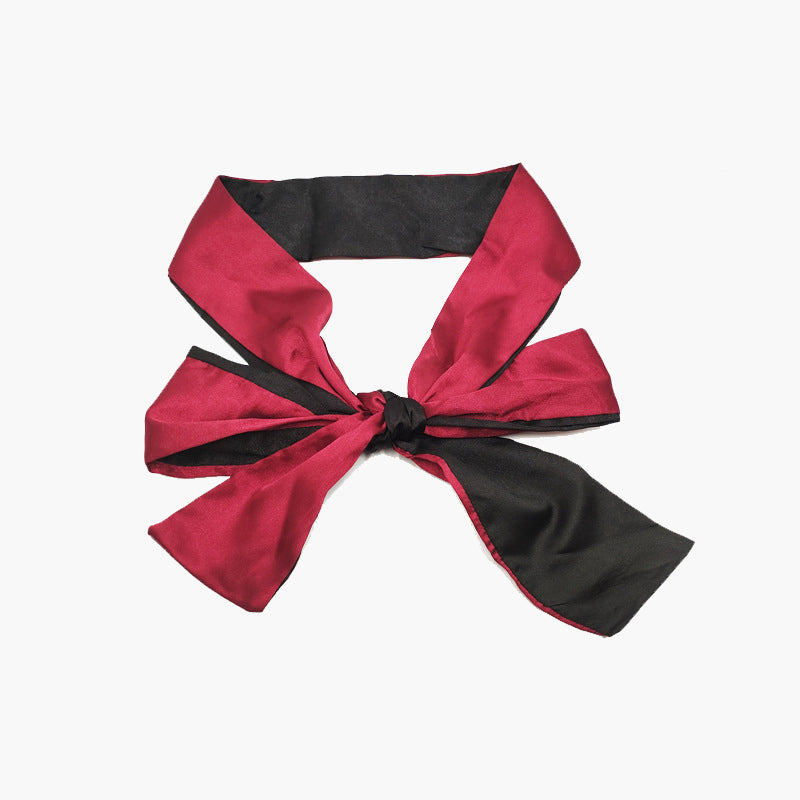 Adjustable satin eye mask in red and black, ideal for meditation, travel, or romantic use