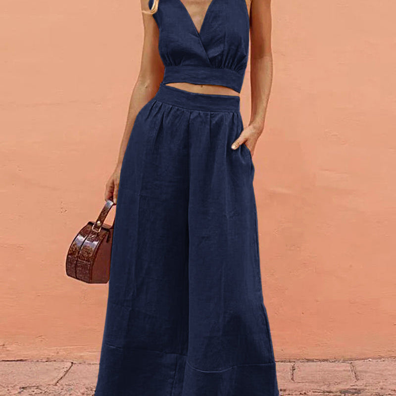 Navy blue two-piece set: crop top and wide-leg pants. Vacation style, navy blue outfit for leisure.