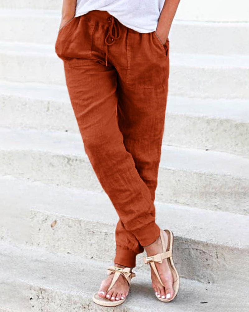 Rust-colored drawstring jogger pants with pockets, casual style, perfect for leisure and daily wear.