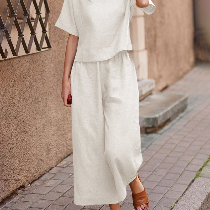 Loose fit two piece set: white short-sleeve top and wide-leg cropped pants