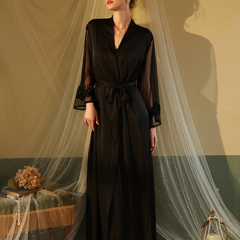 Black satin night robe with lace sleeves, perfect for relaxing evenings. Silky smooth material.