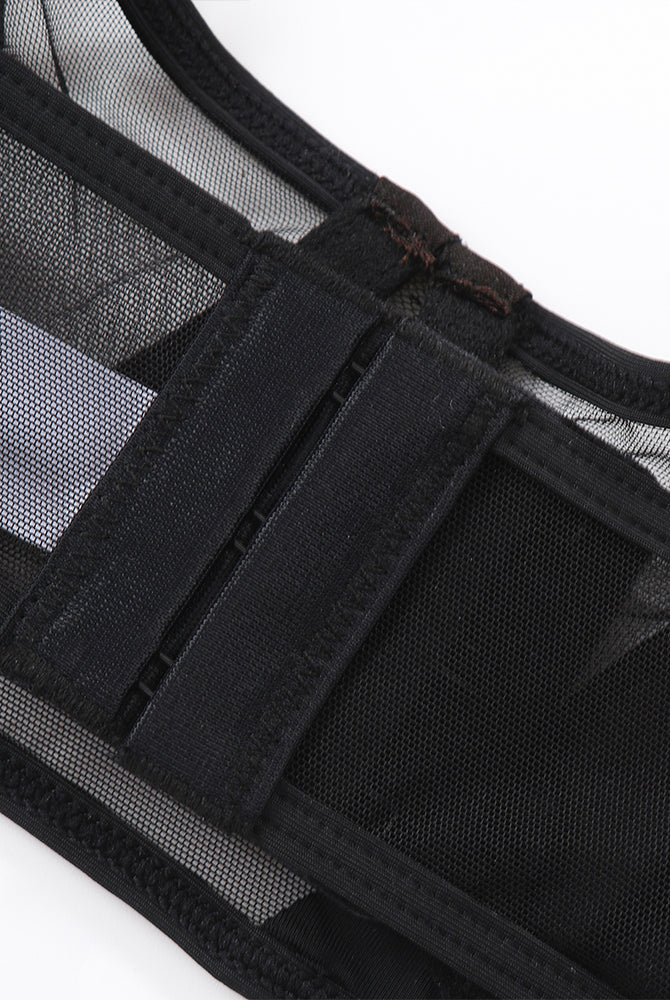 Black mesh push-up bra detail with adjustable straps and hook closure. Seductive lingerie.