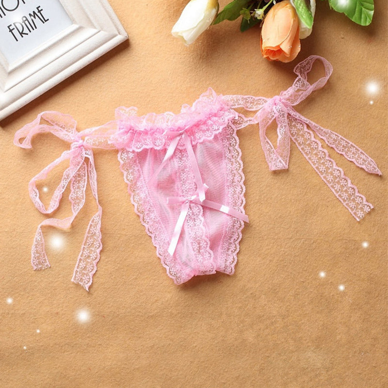 Pink lace crotchless thong with lace-up straps and bow at front.